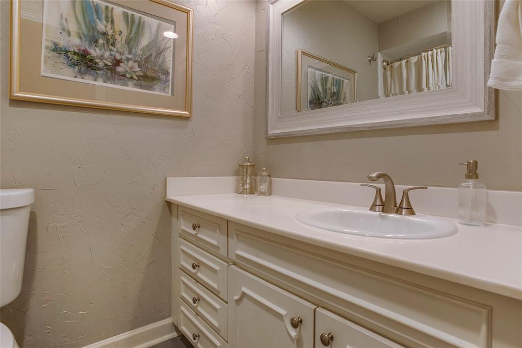 7777 Royal Lane Dallas, TX 75230 - Photo 20 of 30 a bathroom with a sink and a mirror