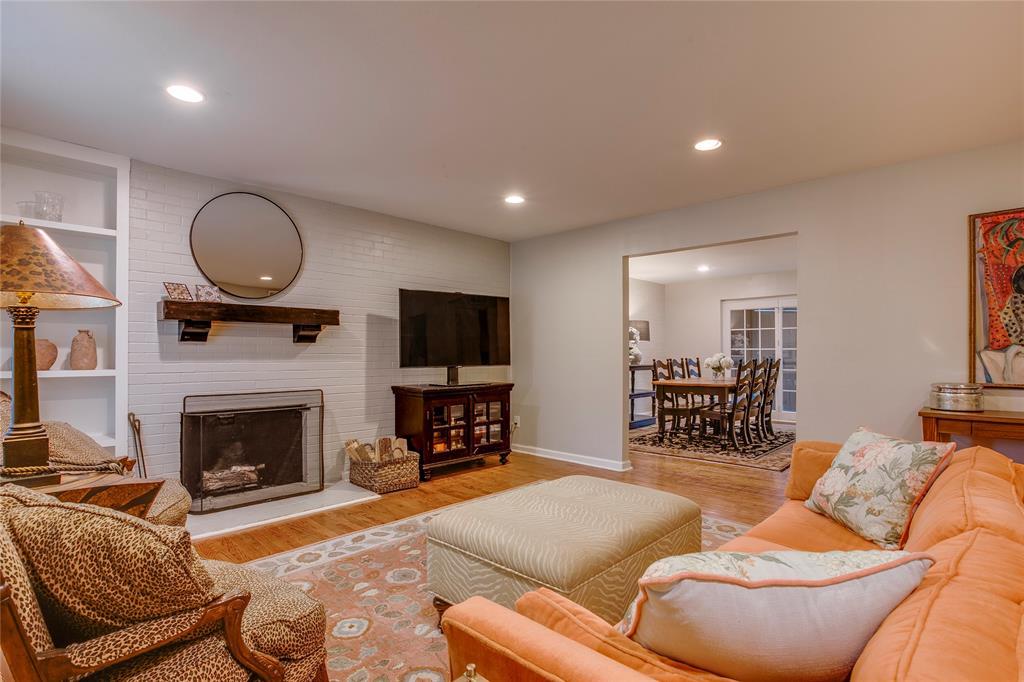 7777 Royal Lane Dallas, TX 75230 - Photo 2 of 30 a living room with furniture a fireplace and a flat screen tv