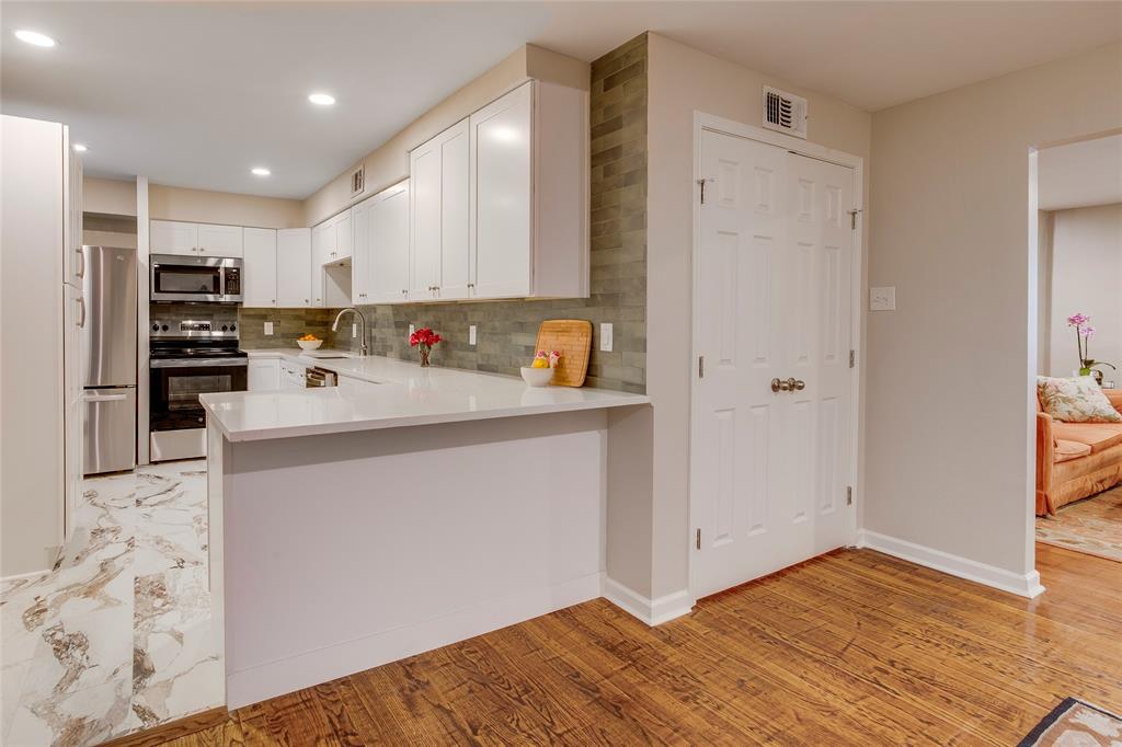 7777 Royal Lane Dallas, TX 75230 - Photo 21 of 30 a kitchen with stainless steel appliances a refrigerator and a stove top oven
