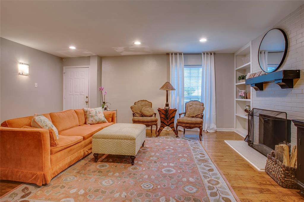 7777 Royal Lane Dallas, TX 75230 - Photo 7 of 30 a living room with furniture a fireplace and a potted plant