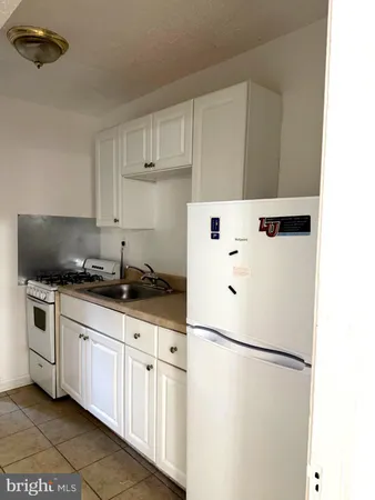 a white refrigerator freezer sitting inside of a kitchen