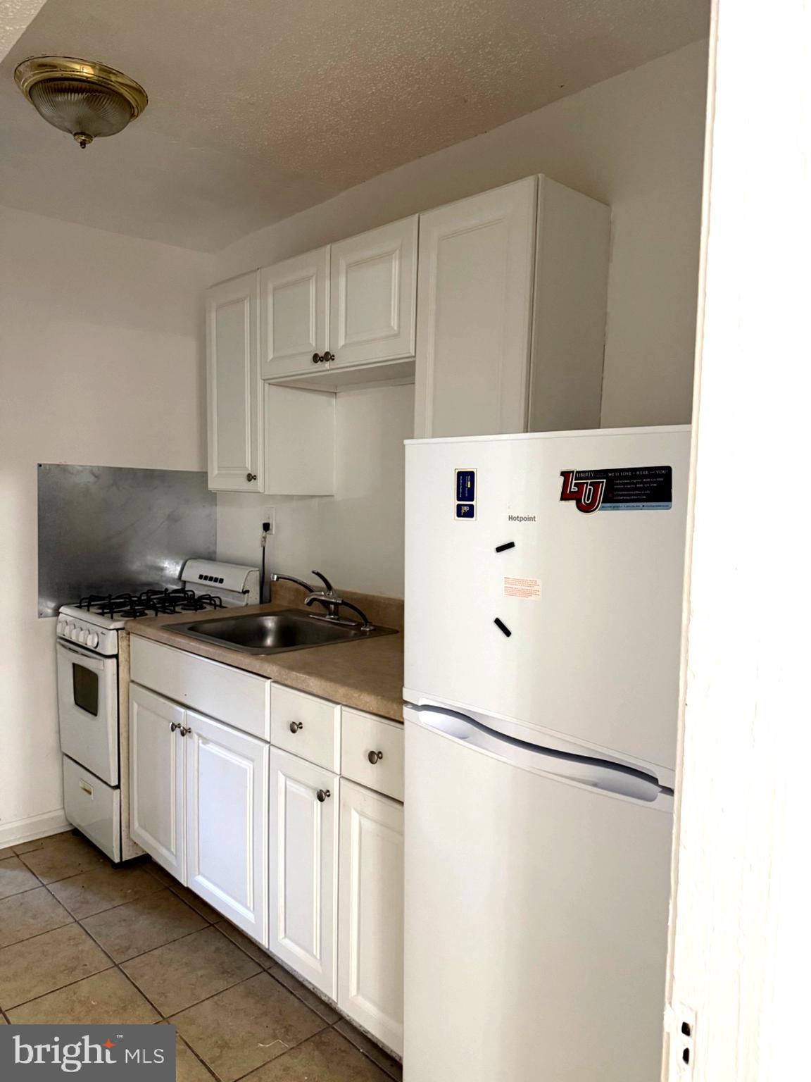 1226 18th Place Northeast Washington, DC 20002 - Photo 3 of 3 a white refrigerator freezer sitting inside of a kitchen