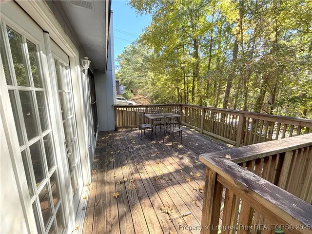 a view of balcony with wooden floor and fence