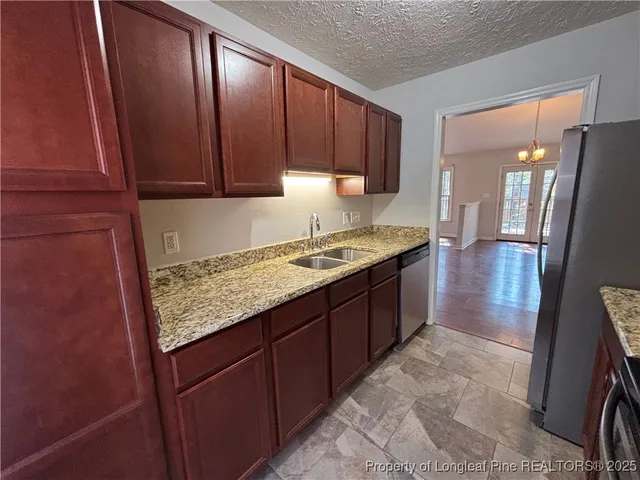 a kitchen with a sink a stove and cabinets