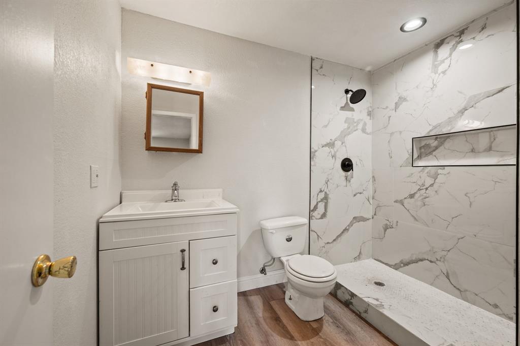 7260 Hudson Cemetery Road Mansfield, TX 76063 - Photo 29 of 40 Bathroom featuring a walk-in shower with large format marble-look tile, matte black fixtures, and a recessed niche