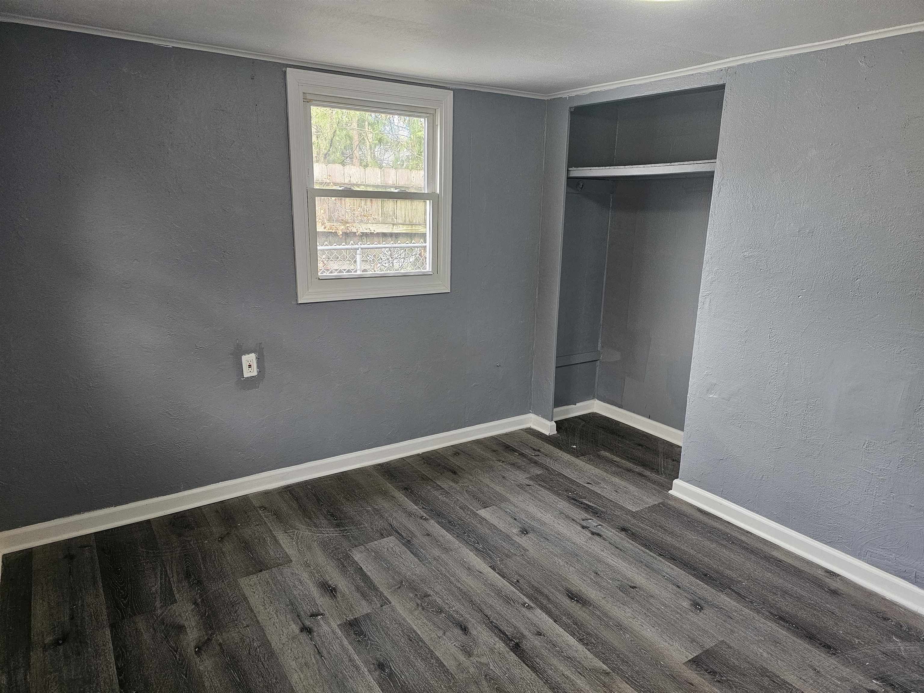 7913 Mildred Road Machesney Park, IL 61115 - Photo 12 of 20 a view of an empty room with wooden floor and a window