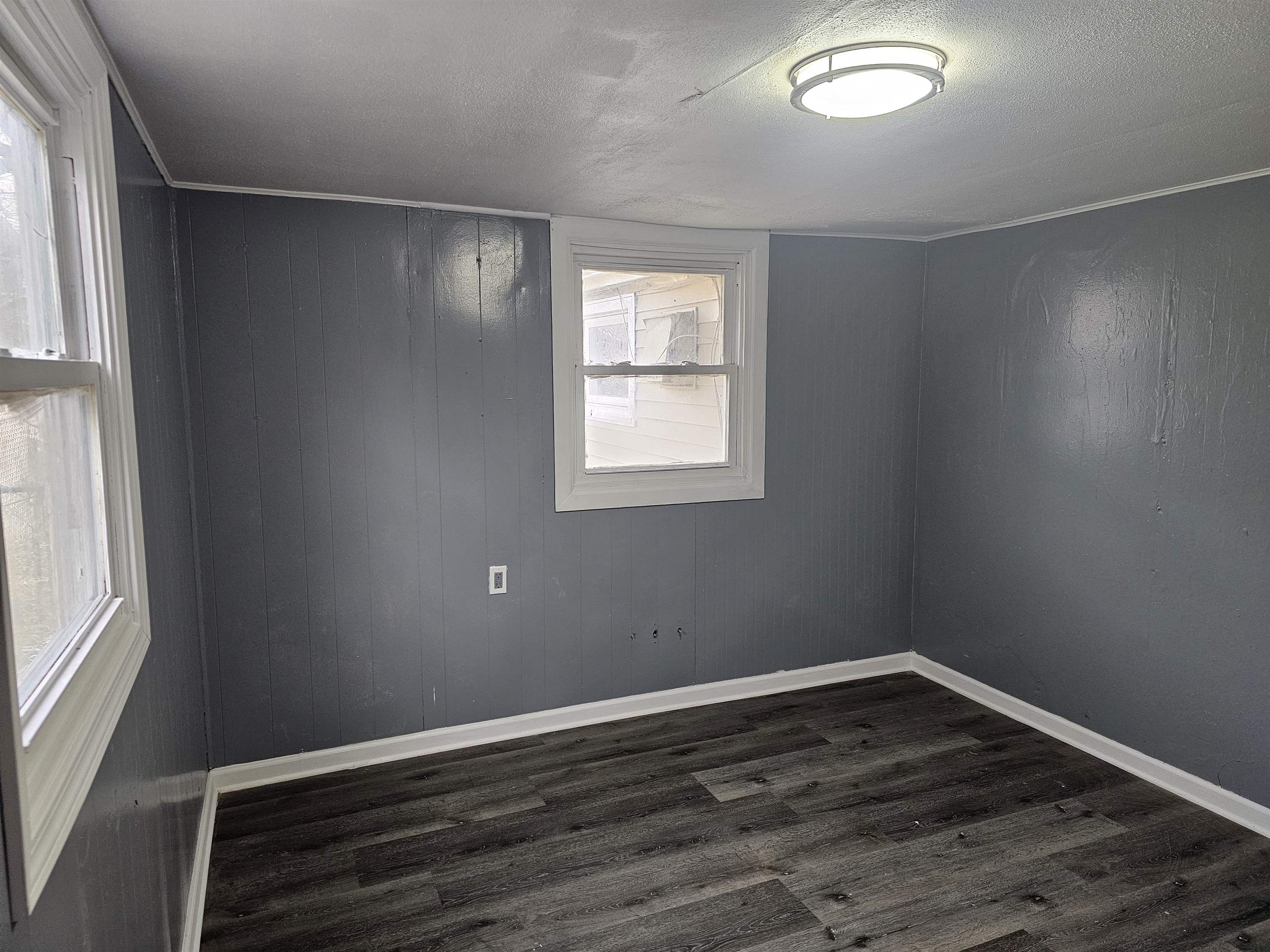 7913 Mildred Road Machesney Park, IL 61115 - Photo 14 of 20 a view of an empty room with wooden floor and a window