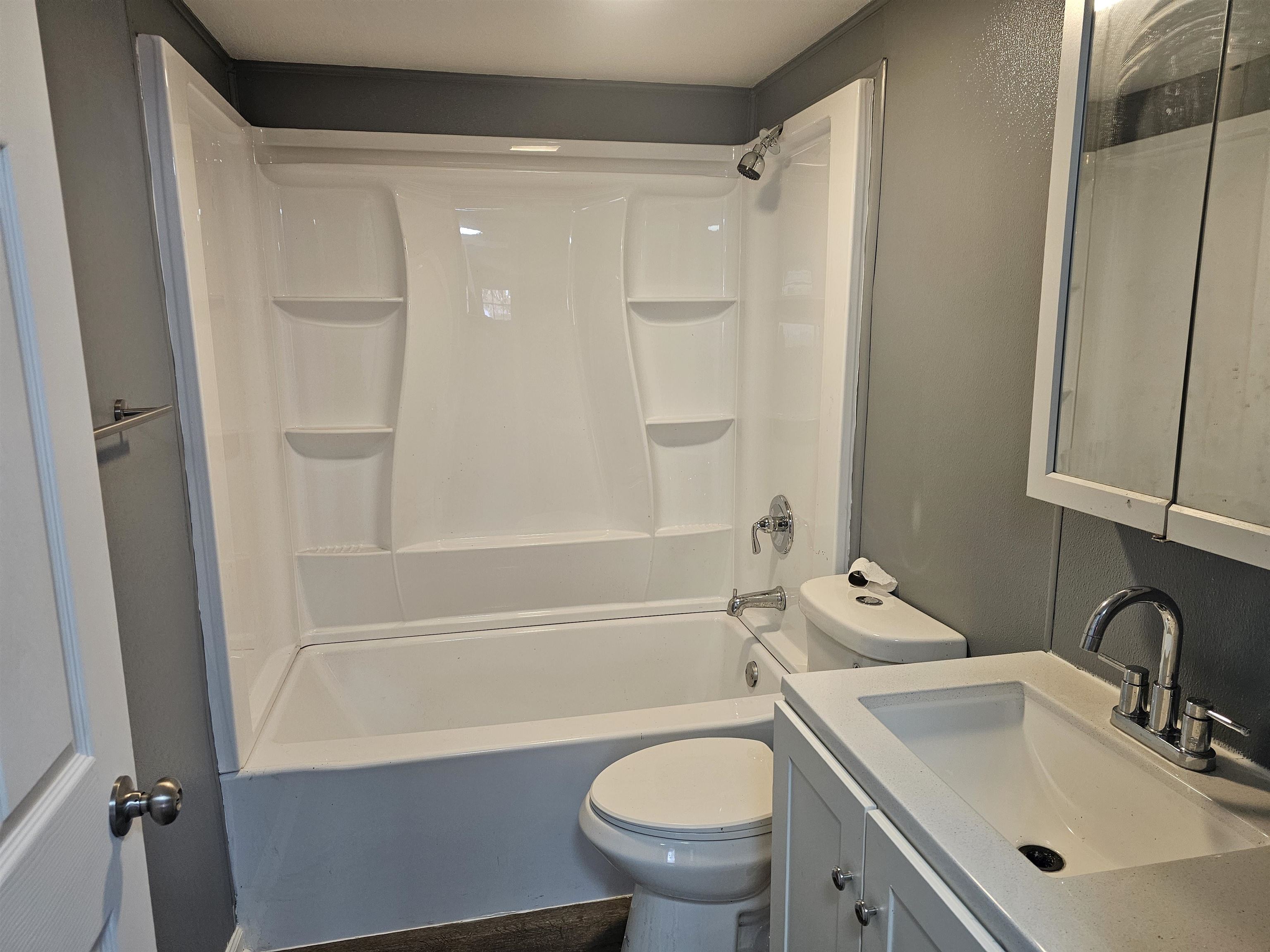 7913 Mildred Road Machesney Park, IL 61115 - Photo 15 of 20 a bathroom with a sink toilet and shower