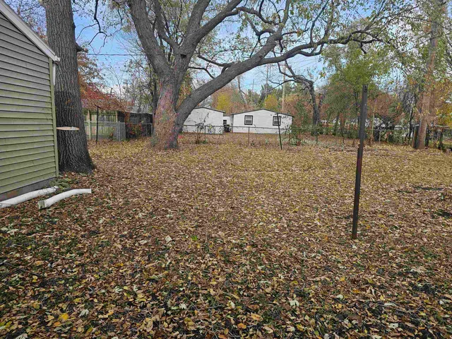 a view of a yard with a tree