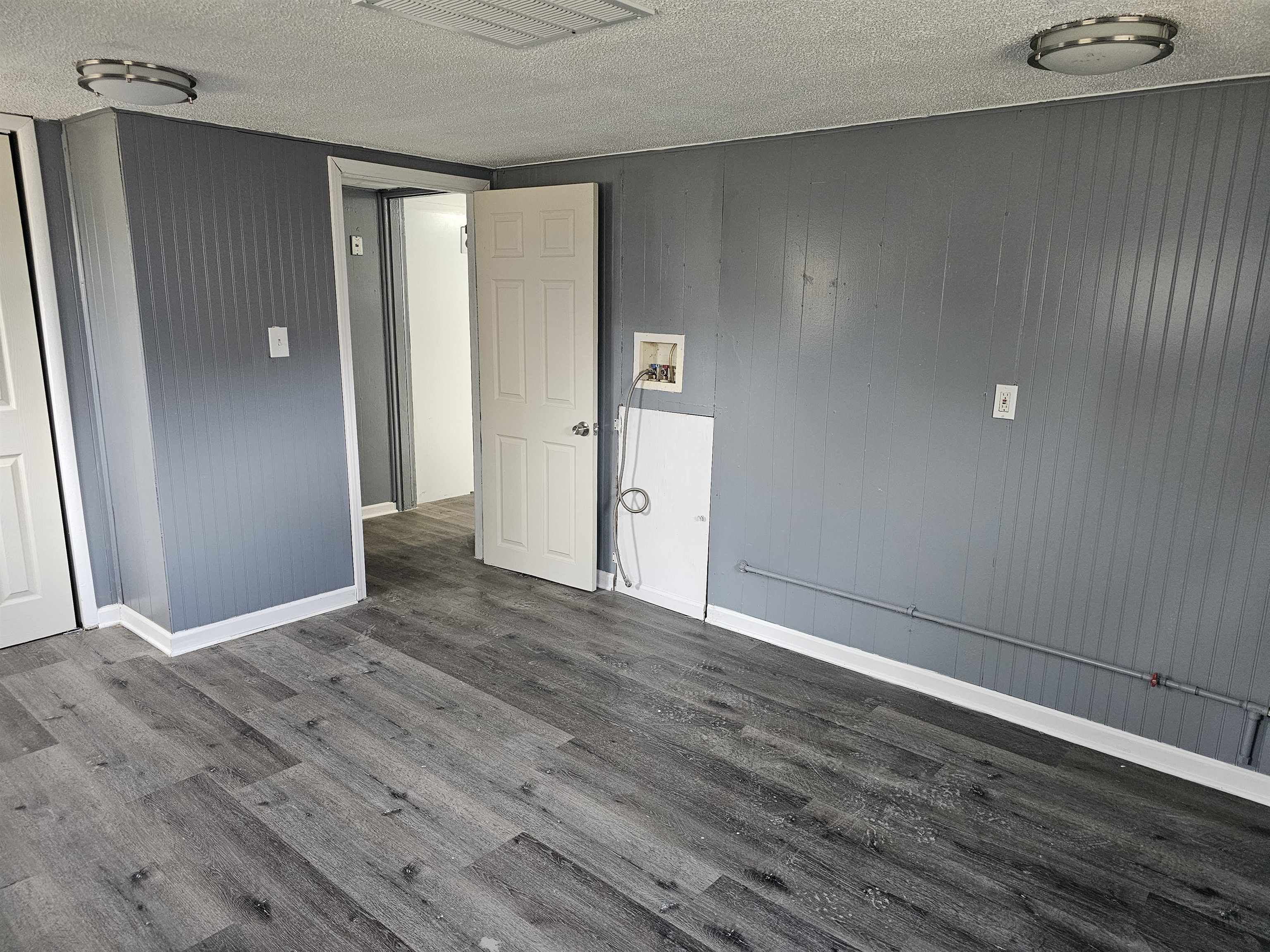 7913 Mildred Road Machesney Park, IL 61115 - Photo 9 of 20 a view of an empty room with wooden floor and a window