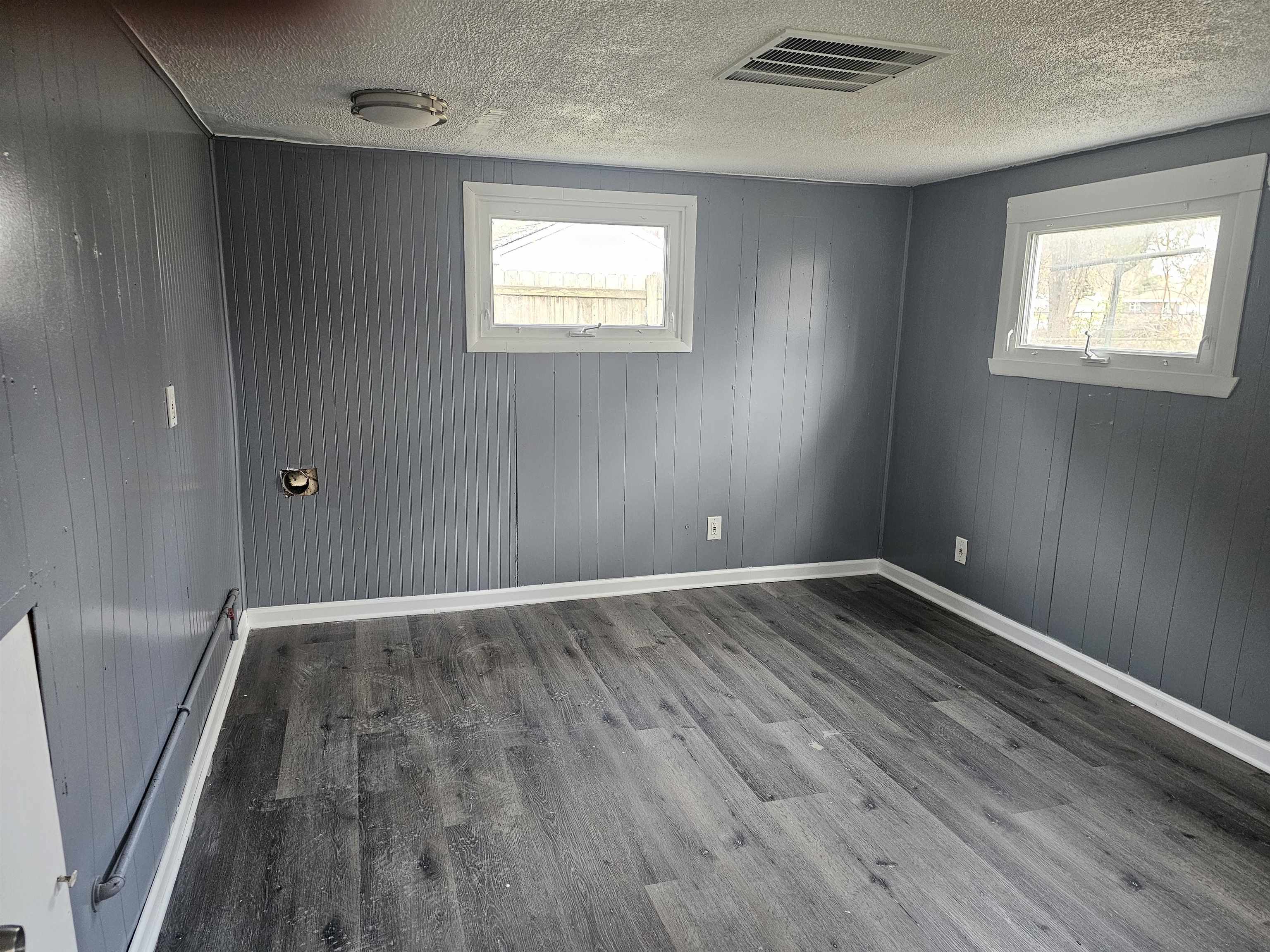 7913 Mildred Road Machesney Park, IL 61115 - Photo 10 of 20 an empty room with wooden floor and windows