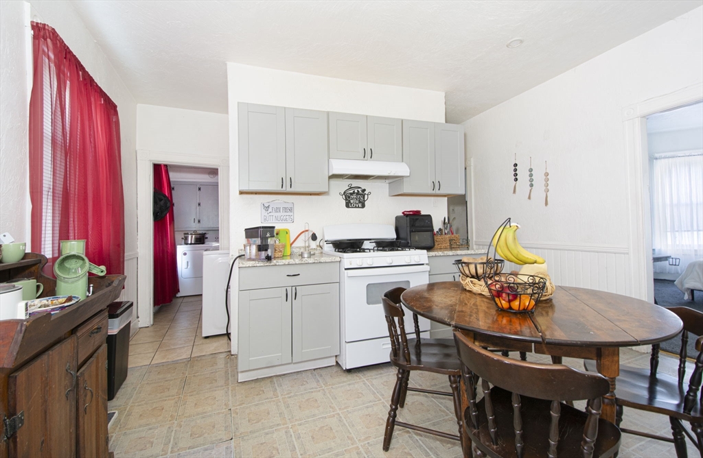 109 Merrifield Street Worcester, MA 01605 - Photo 11 of 21 a kitchen with stainless steel appliances granite countertop a dining table and chairs