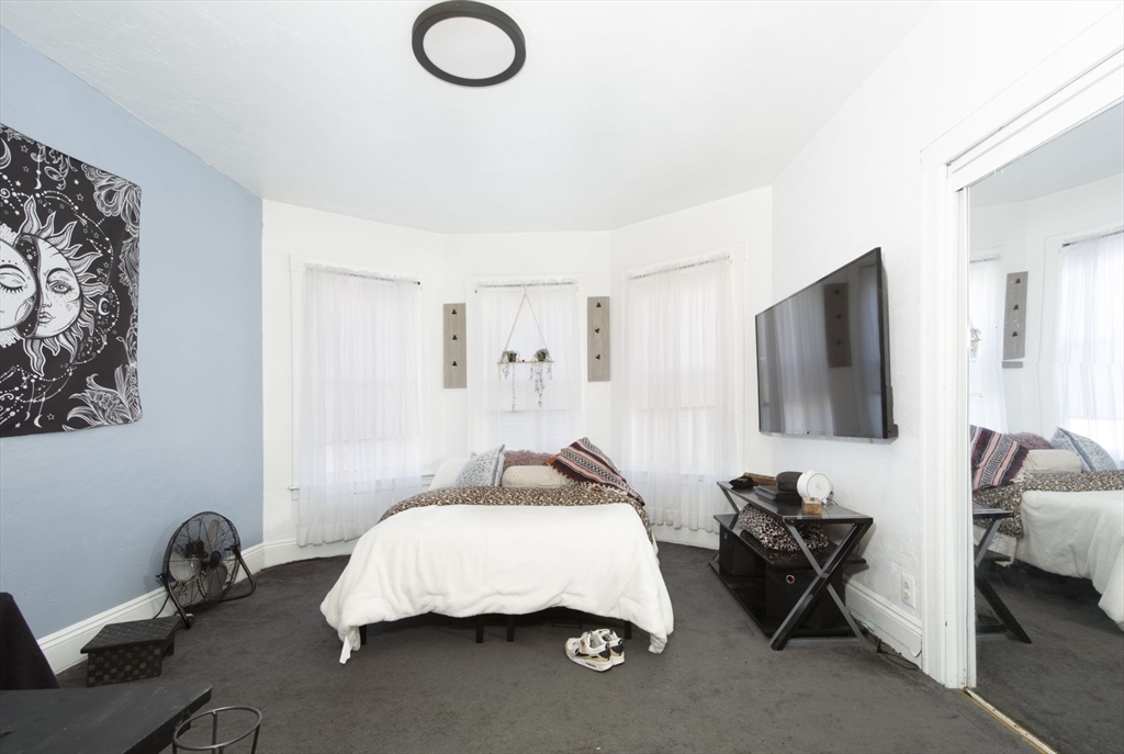 109 Merrifield Street Worcester, MA 01605 - Photo 12 of 21 a bedroom with bed and a flat screen tv