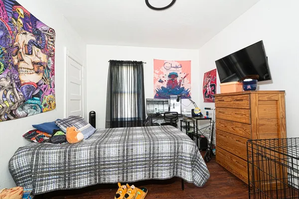 a bedroom with a bed and flat screen tv