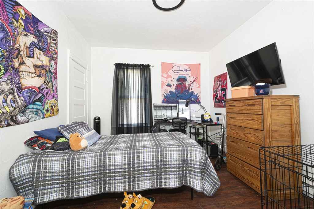 109 Merrifield Street Worcester, MA 01605 - Photo 13 of 21 a bedroom with a bed and flat screen tv
