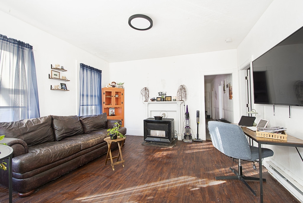 109 Merrifield Street Worcester, MA 01605 - Photo 15 of 21 a living room with furniture flat screen tv and a fireplace
