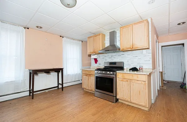 a kitchen with stainless steel appliances granite countertop a stove a sink and a refrigerator