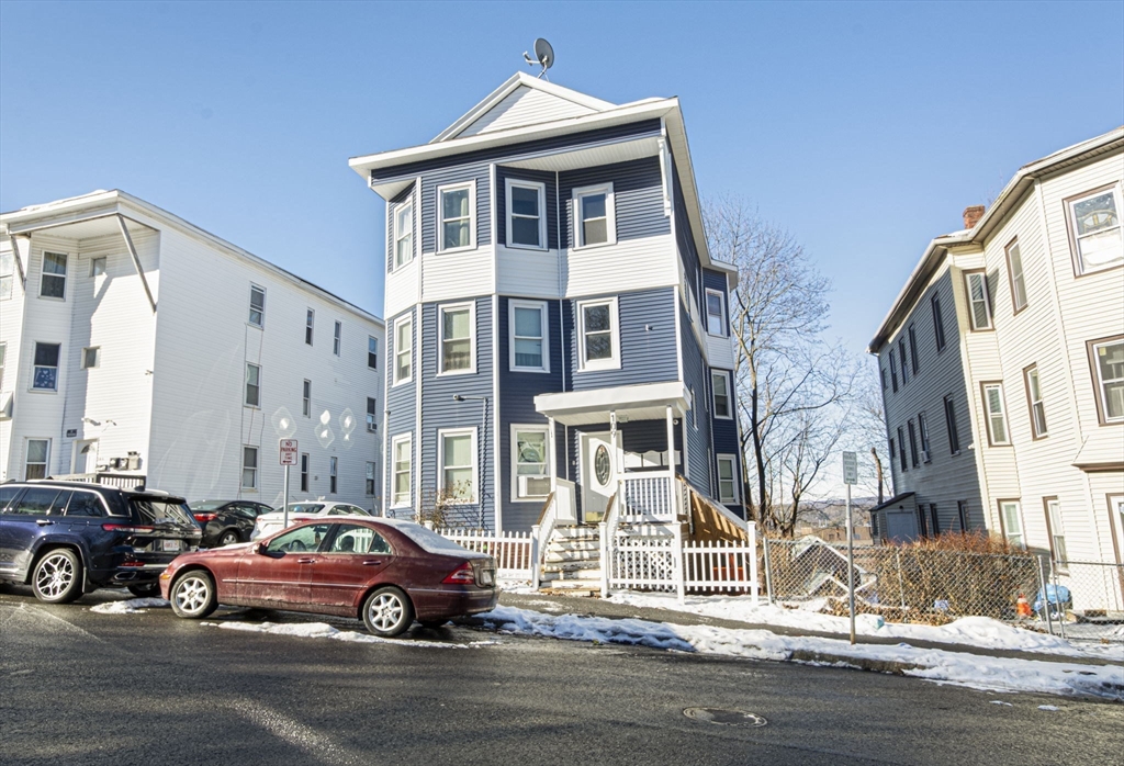 109 Merrifield Street Worcester, MA 01605 - Photo 2 of 21 a car parked in front of a white house