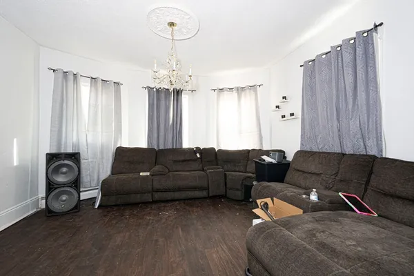 a living room with furniture and a chandelier