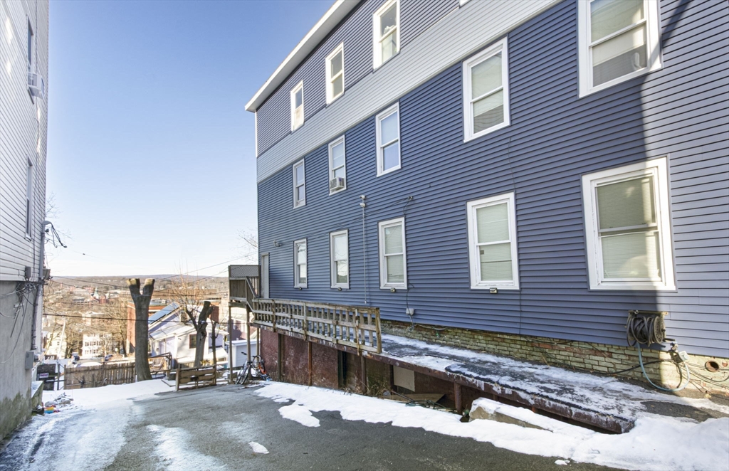 109 Merrifield Street Worcester, MA 01605 - Photo 3 of 21 a view of a brick building next to a yard