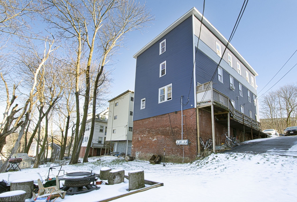 109 Merrifield Street Worcester, MA 01605 - Photo 4 of 21 a front view of a building with large trees