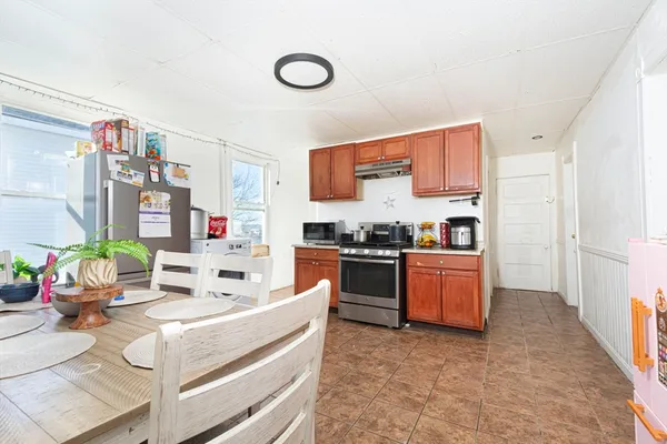 a kitchen with stainless steel appliances kitchen island granite countertop a stove and a sink