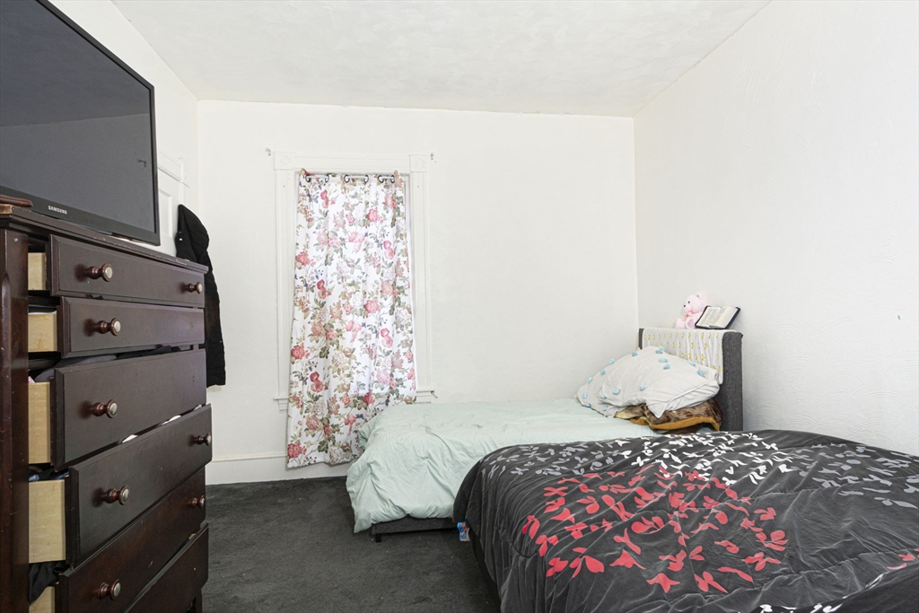 109 Merrifield Street Worcester, MA 01605 - Photo 8 of 21 a bedroom with a bed and a cabinets
