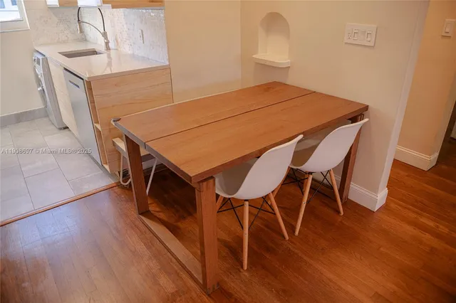 a dining room with furniture and wooden floor