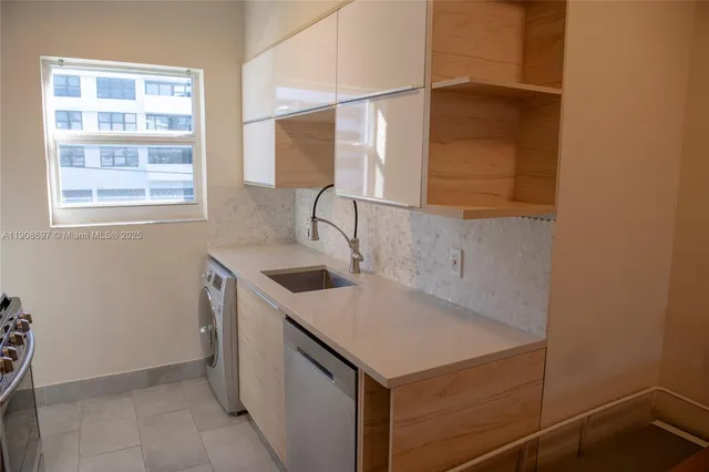 a kitchen with a sink cabinets and window