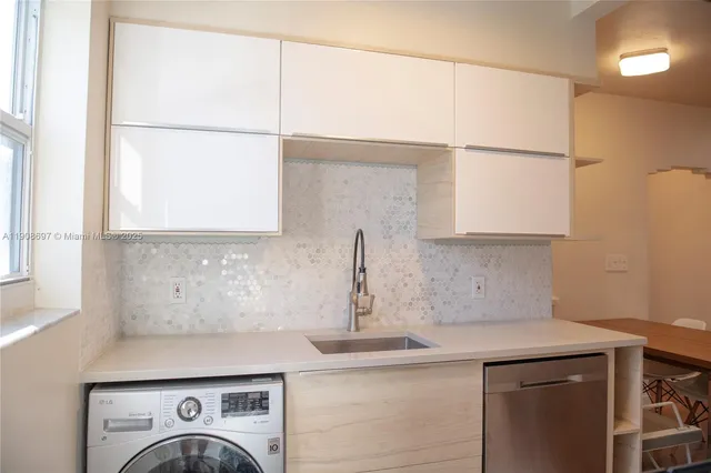 a view of a kitchen with a sink cabinets and a window