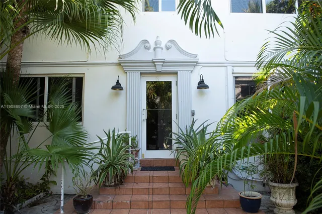 front view of house with potted plants