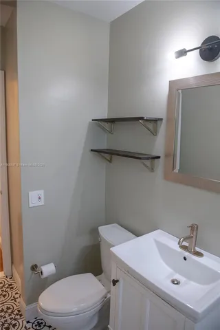 a bathroom with a sink a toilet and vanity