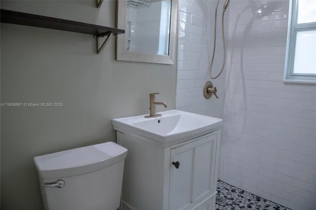 a bathroom with a sink a toilet and a shower