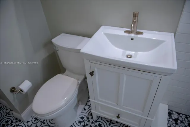 a white toilet sitting next to a sink