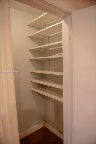 a view of walk in closet with empty racks