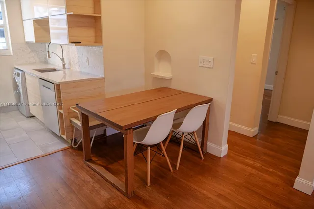 a view of a dining room with furniture and wooden floor