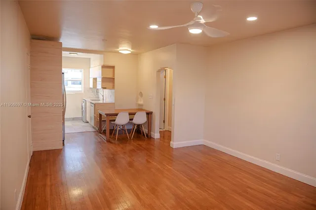 a view of a room with wooden floor and a sink