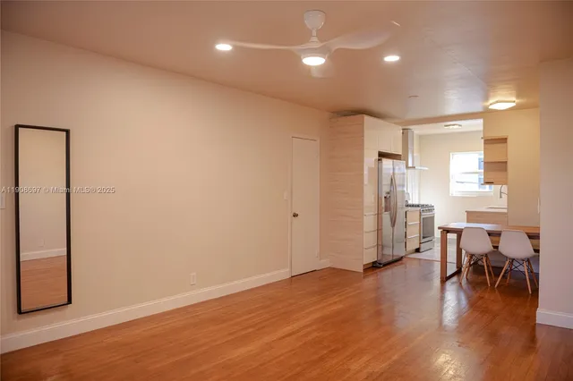 a view of a room with wooden floor and windows