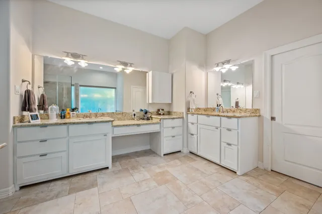 a bathroom with a sink vanity and mirror