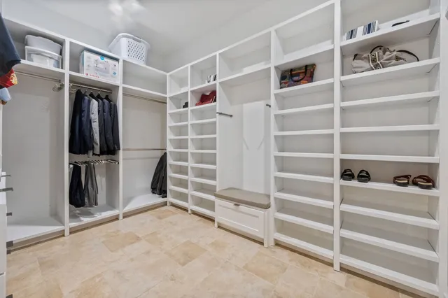 a view of walk in closet with empty racks