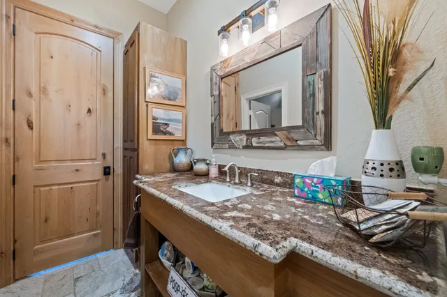 a bathroom with sink granite and a mirror