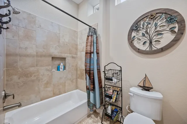 a bathroom with a toilet and a bathtub