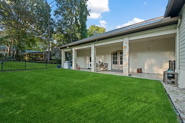 a backyard of a house with table and chairs