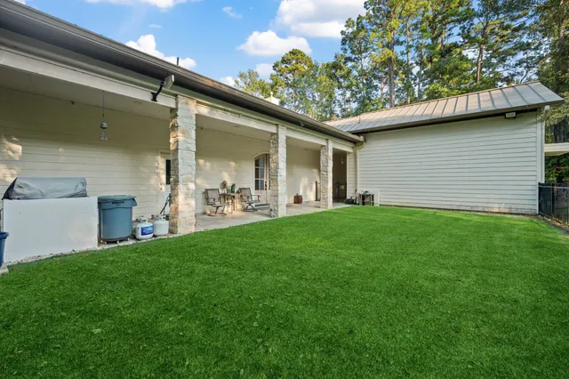 a backyard of a house with table and chairs