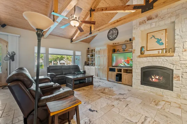 a living room with furniture a flat screen tv and a fireplace