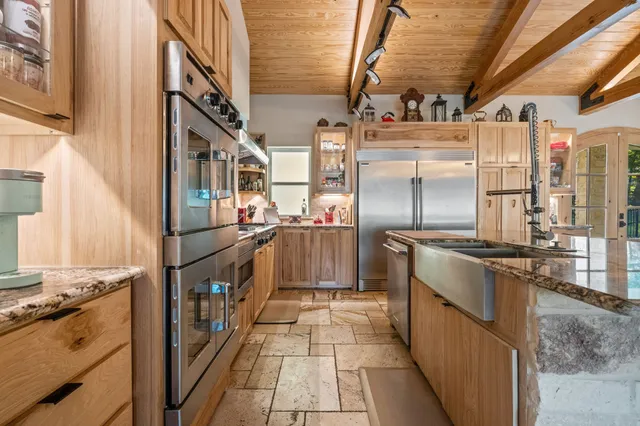 a kitchen with refrigerator and stove
