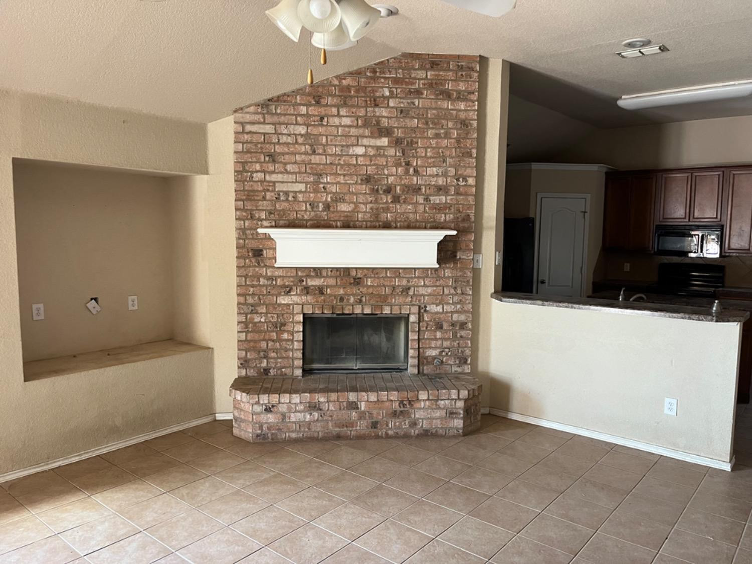 3601 Pontiac Avenue Lubbock, TX 79407 - Photo 3 of 14 a living room with a fireplace