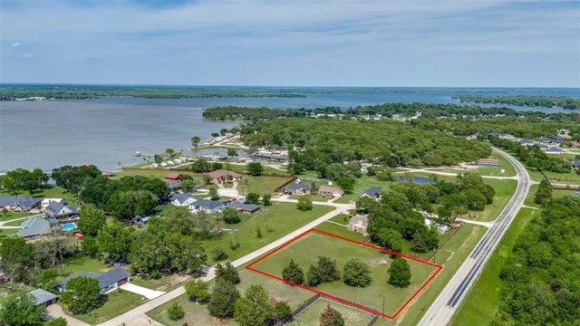 an aerial view of lake and residential houses with outdoor space
