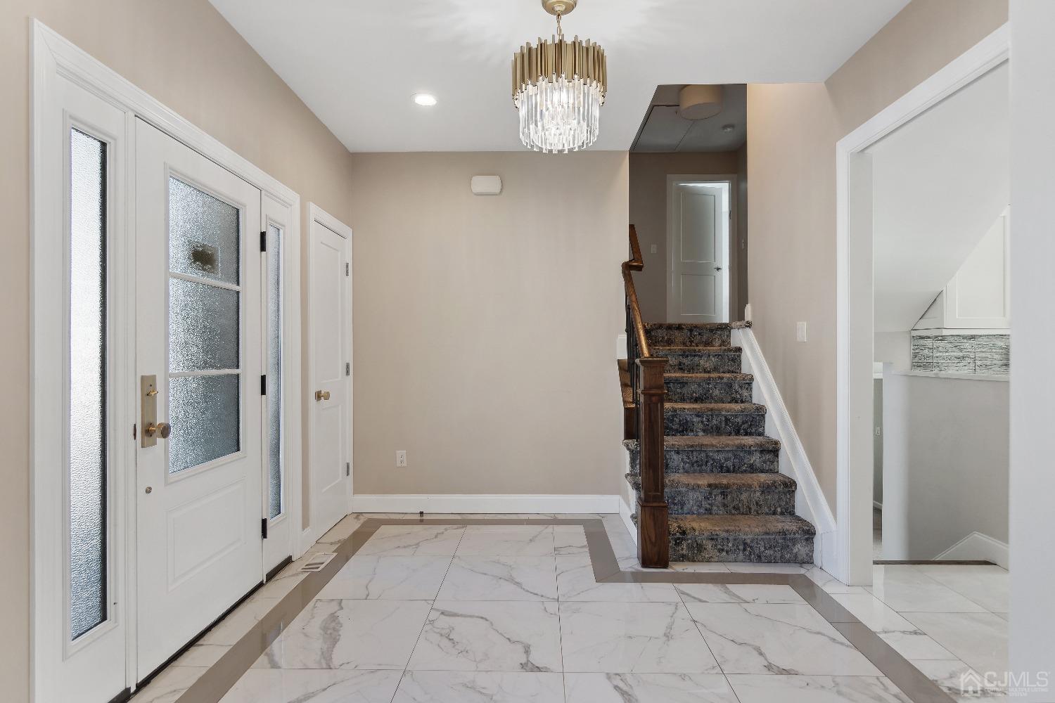 6 Barlow Road Edison, NJ 08817 - Photo 3 of 44 a view of a hallway with wooden floor and staircase