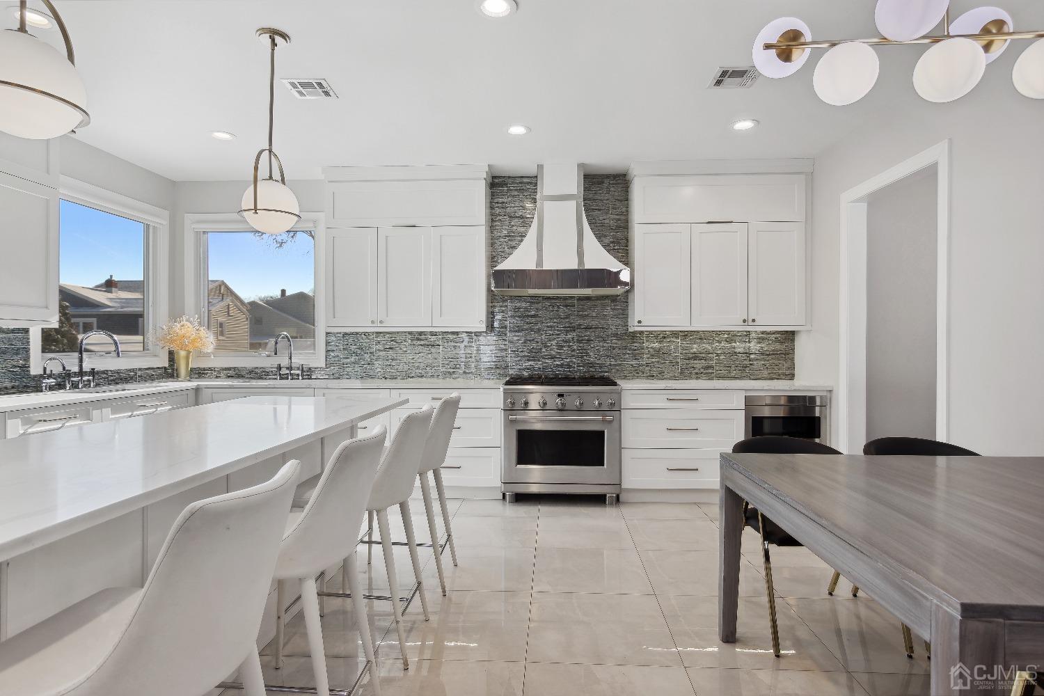 6 Barlow Road Edison, NJ 08817 - Photo 7 of 44 a kitchen with kitchen island granite countertop a stove a sink a center island and cabinets